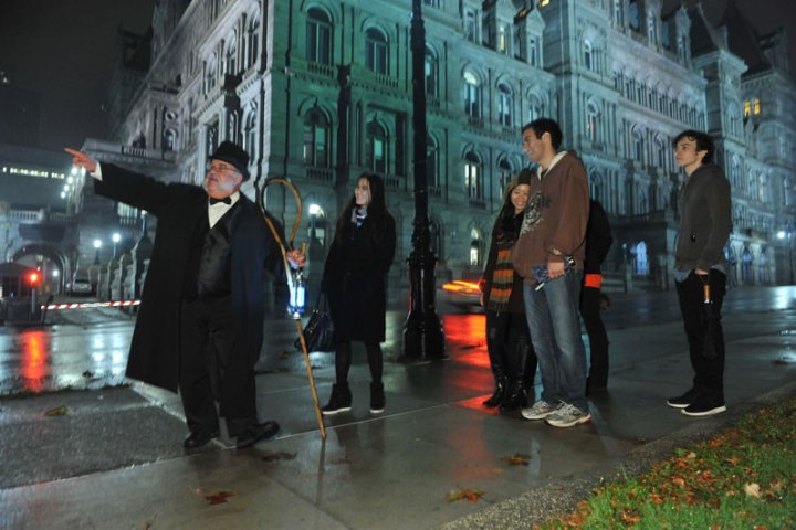 a group of people walking on a city street